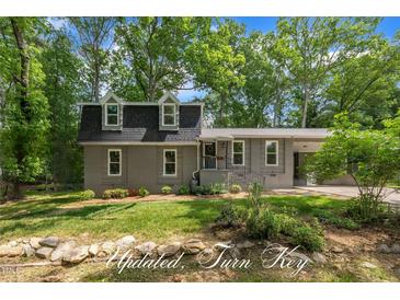 Charming two-story home with a well-manicured front yard and inviting curb appeal at 202 Brook Ln, Durham, NC 27712
