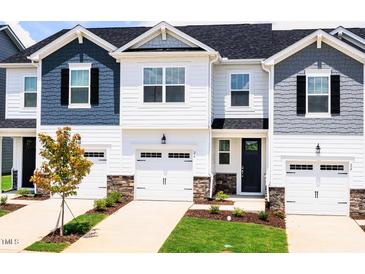 New townhomes feature attached garages, black shutters, manicured lawns, and Craftsman-style details at 26 Twin Birch Dr, Angier, NC 27501