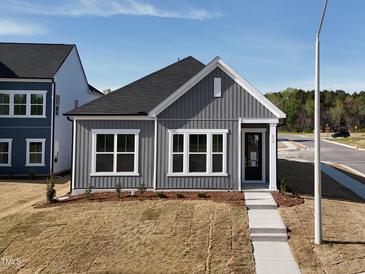 Charming home featuring gray siding, white trim, well-manicured lawn, and a welcoming walkway at 273 Marvel Dr # 139, Rolesville, NC 27571