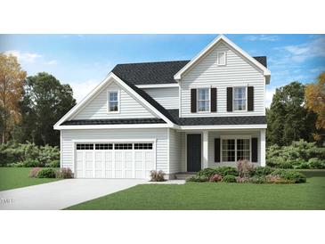 Charming two-story home featuring a classic design, well-maintained landscaping, and attached two-car garage at 913 Thimbleweed Way, Wake Forest, NC 27587