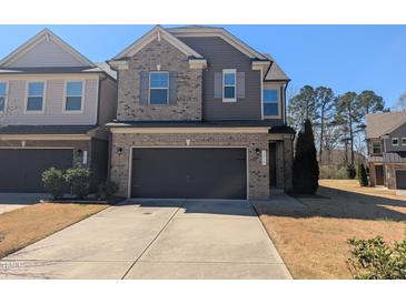 Charming two-story home with a two-car garage and inviting brick and siding exterior at 1015 Rexburg Dr, Cary, NC 27513