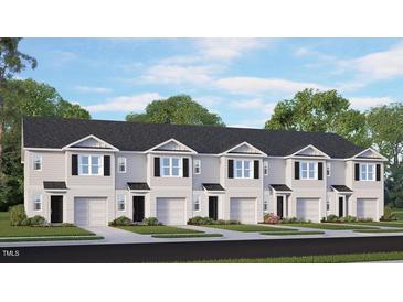 Charming townhome exteriors featuring black shutters, gray siding, and a one-car garage for convenient parking at 119 Holton St, Smithfield, NC 27577