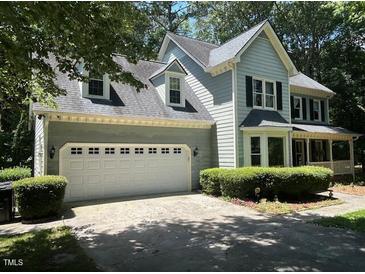 Charming two-story home featuring a front-facing two car garage and traditional architectural elements at 1501 Ramson Ct, Raleigh, NC 27603