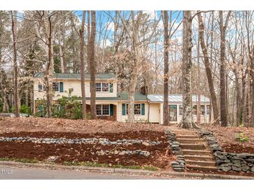 Charming two-story home with a landscaped front yard and stone steps leading to the entrance at 203 Lexington Rd, Chapel Hill, NC 27516