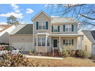 Charming two-story home featuring a covered front porch, bay window, and well-maintained landscaping at 2152 Haig Point Way, Raleigh, NC 27604