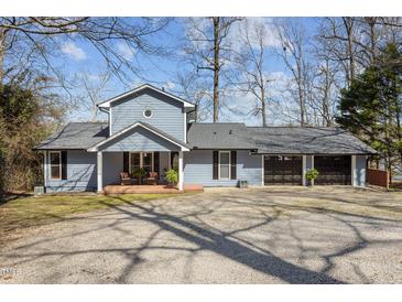 Charming two-story home with a spacious front yard and attached three car garage at 220 Choctaw Dr, Louisburg, NC 27549
