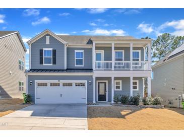 Charming two-story home with a covered porch and a two-car attached garage at 3381 Lovage Dr, Apex, NC 27502