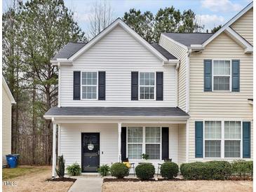 Charming two-story home with covered porch and manicured landscaping at 3924 Volkswalk Pl, Raleigh, NC 27610