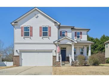 Charming two-story home featuring a well-manicured lawn and an inviting front porch perfect for relaxing at 505 Ferry Ct, Wake Forest, NC 27587