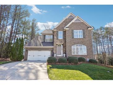 Beautiful two-story brick home featuring manicured landscaping, a two-car garage, and a welcoming front entrance at 508 Spencer Crest Ct, Cary, NC 27513