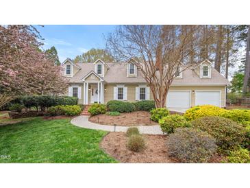 Charming traditional home featuring a well-manicured lawn, blooming trees, and inviting curb appeal at 8 Bryncastle Ct, Durham, NC 27707