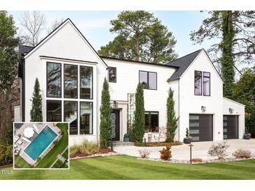 Stunning modern home with crisp white exterior, black trim, and beautifully manicured lawn at 1323 Ridge Rd, Raleigh, NC 27607