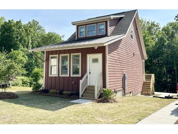 Charming, two-story home with a metal roof, craftsman trim and a neatly manicured lawn at 1448C Maplewood Dr, Durham, NC 27704
