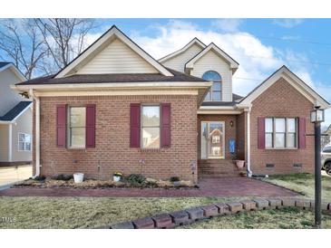 Charming brick home featuring burgundy shutters and a manicured front yard landscape at 1709 Shamrock Ln, Rocky Mount, NC 27804