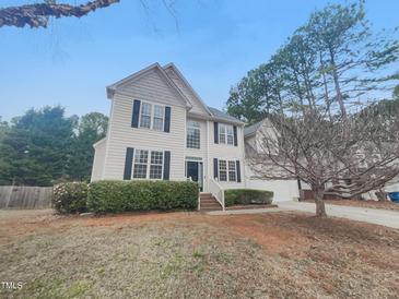 Charming two-story home featuring landscaped front yard, attached garage, and neutral color palette at 1908 Mystic Dr, Durham, NC 27712