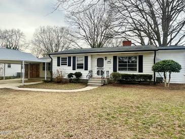 Charming one-story home with white siding, black shutters, and a covered carport at 215 Sallinger St, Knightdale, NC 27545
