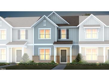 Charming townhome featuring eye-catching exterior, gray siding, and a welcoming covered entry at 387 Fosterton Cottage Way, Raleigh, NC 27603