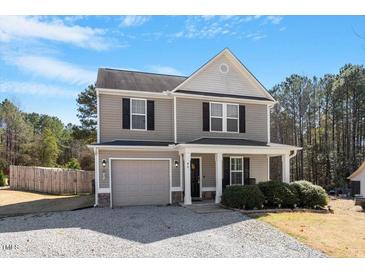 Charming two-story home with grey siding, black shutters, and a cozy front porch at 40 Golden Timber Cir, Four Oaks, NC 27524