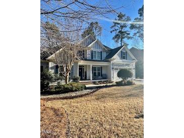 Charming two-story home with a covered front porch and manicured landscaping, perfect for curb appeal at 528 Opposition Way Way, Wake Forest, NC 27587