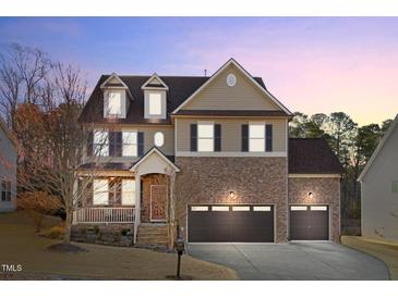 Beautiful two-story home with a well-manicured lawn and three-car garage at 7520 Channery Way, Raleigh, NC 27616