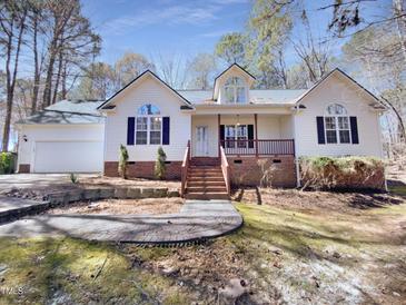 Charming single Gathering home featuring a cozy front porch and well-maintained landscaping at 110 Chickasaw Cir, Clayton, NC 27527