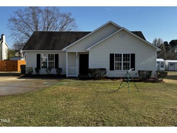 Charming one-story home featuring well-manicured lawn and classic curb appeal at 128 Glengariff Ln, Clayton, NC 27520
