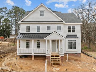 Beautiful two-story home with a covered porch and black accents against the white siding at 207 Holleman St, Apex, NC 27502