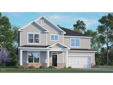 Charming two-story home featuring a classic gray exterior, well-manicured lawn and a welcoming covered front porch at 265 Umstead St, Sanford, NC 27330