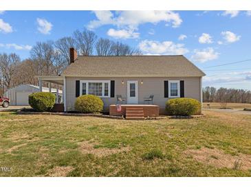Charming single-story home with manicured bushes and a quaint brick entryway at 3307 Altamahaw Church St, Elon, NC 27244