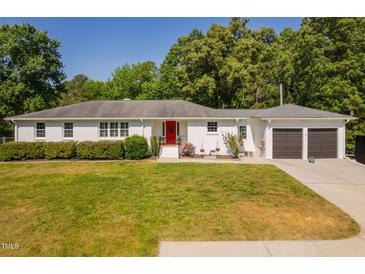 Charming, white-brick home with a well-manicured lawn and eye-catching red front door at 4200 Us 1 Highway South, Kittrell, NC 27544