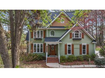 Charming two-story home featuring a gabled roof, wood shutters and trim, and manicured landscaping at 5504 Quails Call Ct, Garner, NC 27529