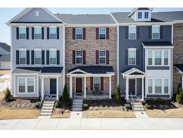 Charming townhome exterior with covered entryway and well-maintained landscaping at 5917 Kayton St, Raleigh, NC 27616