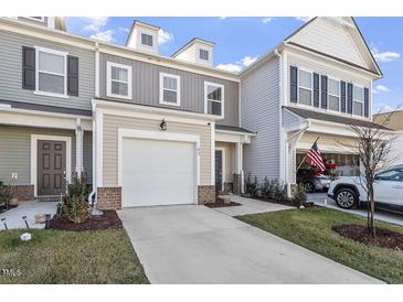 Charming townhome featuring a garage and a well-maintained lawn, perfect for comfortable living at 63 Pale Moss Dr, Clayton, NC 27527
