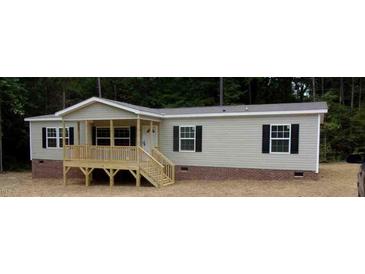 Charming single-story home with a inviting front porch and neutral siding at 6646 Woodlawn Dr, Oxford, NC 27565