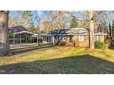Charming brick home featuring a large front yard and convenient carport at 104 Seaman St, Oxford, NC 27565