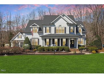 Charming two-story home with a beautifully landscaped yard and welcoming front porch at 1412 Wynncrest Ct, Raleigh, NC 27603
