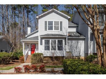 Charming two-story home featuring gray siding, a bright red front door, and well-maintained landscaping at 595 Weathersfield # A, Pittsboro, NC 27312