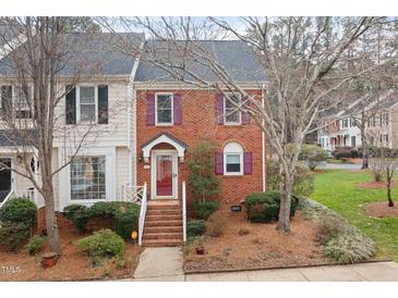 Charming brick townhouse featuring a gray roof and burgundy shutters at 6730 Olde Province Ct, Raleigh, NC 27609