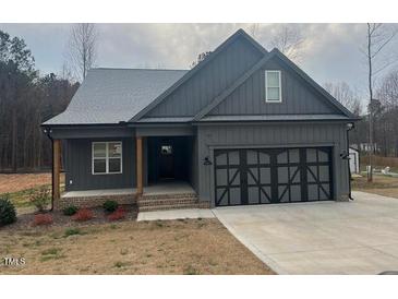 Charming single-story home with a two-car garage and a well-manicured front yard at 945 Lynch Rd, Selma, NC 27576