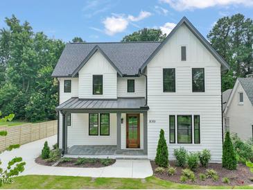 Charming two-story home with a manicured lawn and stylish architectural details at 109 W Markham Ave, Durham, NC 27701
