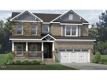 Charming two-story home featuring a welcoming front porch, brick and stone accents, and a two-car garage at 1098 Tulloch Ct # 209, Burlington, NC 27215