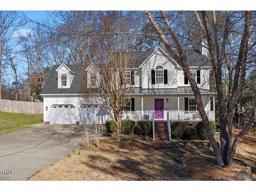 Charming two-story home featuring a two-car garage and inviting front porch with a purple door at 15 Rocky Point Ct, Fuquay Varina, NC 27526