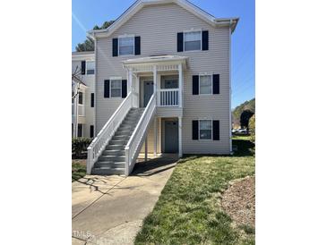 Charming two-story condo featuring a welcoming entrance with a staircase and a well-maintained lawn at 151 Schultz St # 151, Chapel Hill, NC 27514