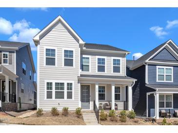 Charming two-story home with light gray siding and a welcoming front porch at 372 Natsam Woods Way, Wake Forest, NC 27587