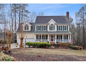 Inviting two-story home featuring a charming front porch with classic columns and a well-manicured landscaped yard at 721 Thompson Rd, Garner, NC 27529