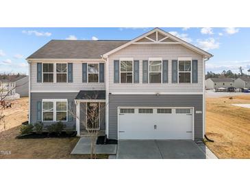 Charming two-story home with gray siding, blue shutters, and a two-car garage at 1122 Briar Rose Ln, Durham, NC 27704