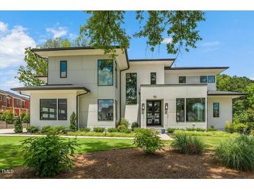 Contemporary two-story home featuring a meticulously landscaped front yard and modern architectural details at 132 Edward Booth Ln, Durham, NC 27713