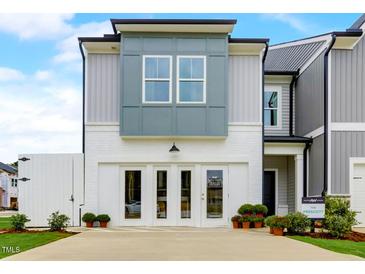 Charming new home exterior with a painted brick garage and complementary colored siding for a modern look at 2001 Regal Dr # 89, Durham, NC 27703