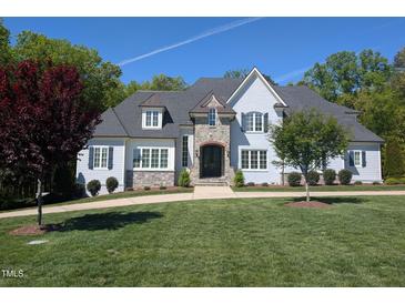 Stately home with lush lawn, stone accents, and charming architectural details at 40 Park Meadow Ln, Youngsville, NC 27596