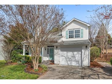 Charming two-story home features a well-maintained front yard, attached garage, and appealing architectural details at 409 Hanson Rd, Durham, NC 27713